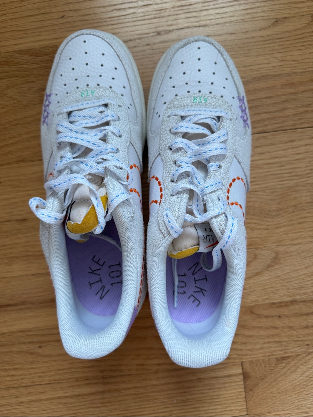 Nike White Low-Top Sneakers with Purple Insoles and Yellow Tongue Tabs